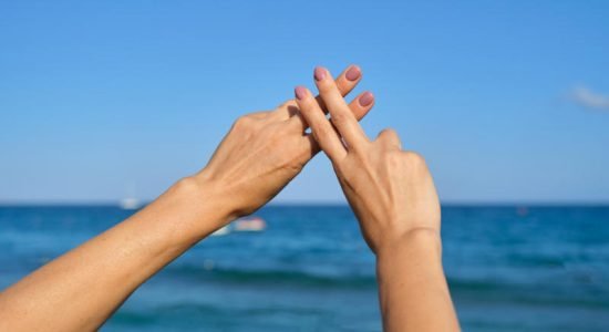 Hands show gesture symbol hashtag is viral, web, social media, network Hands show gesture symbol hashtag is viral, web, social media, network. Background is blue sky sea, concept for marketing, trending, blogging and internet themes
